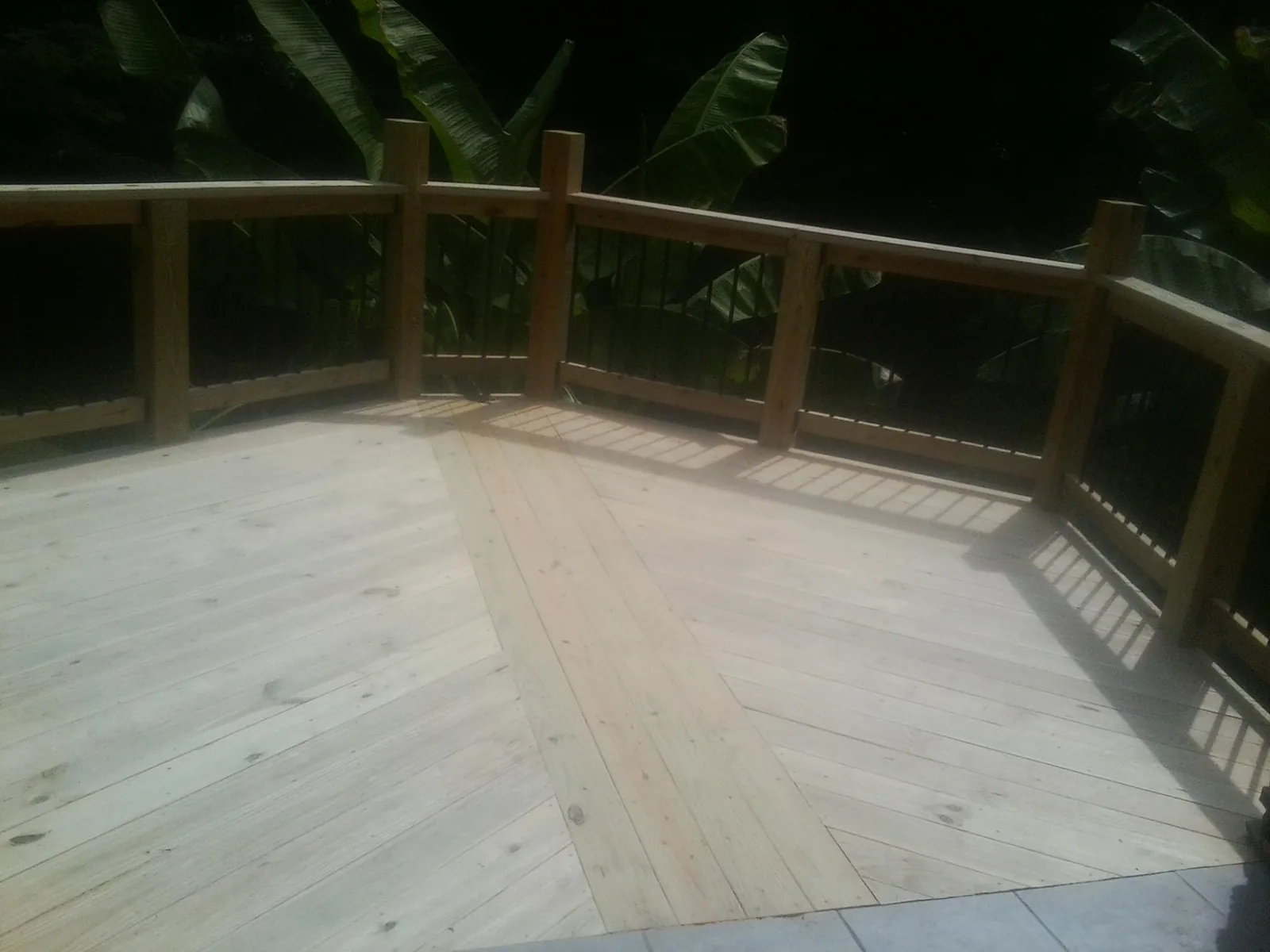 New wood deck and railing built off the back of a home in Farmdale