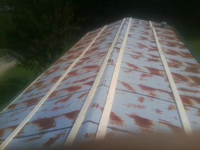 Rusted metal roof panels with new wood purlins before replacement — Storm Damage Roof Repair in Farmdale by Roofing Brothers